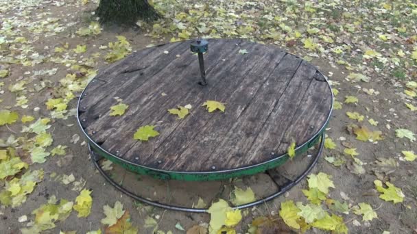 Yellow maple leaves falling on children playground equipment - Footage, Video
