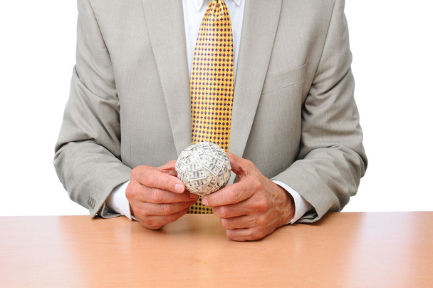 Businessman Seated at Desk With Ball of Money - Fotoğraf, Görsel