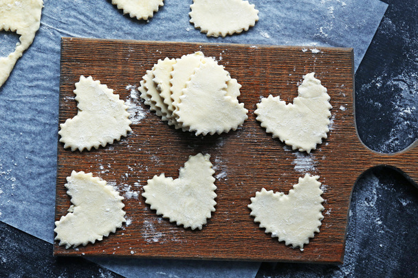 Uncooked heart shaped biscuits on a table - Photo, Image