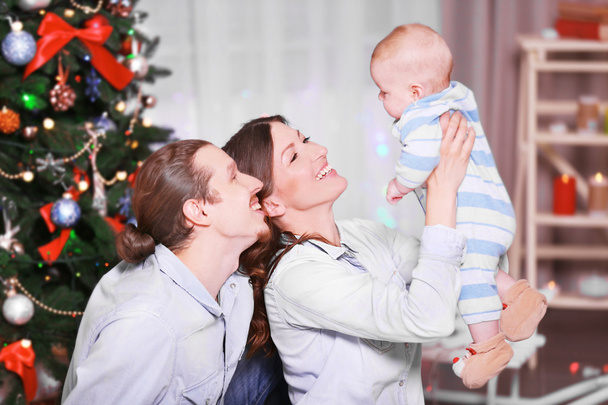 Happy family in decorated Christmas room - 写真・画像