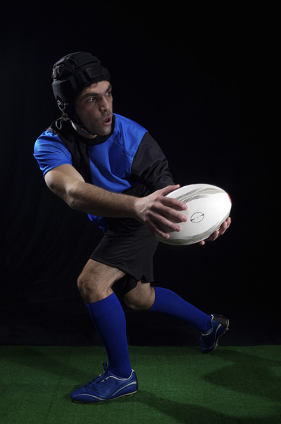 Rugby player with ball - 写真・画像