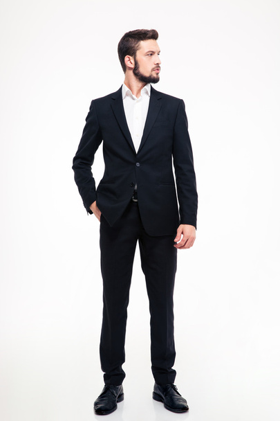 Full length portrait of a confident businessman looking away  - 写真・画像