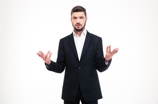 Handsome puzzled businessman with beard holding copyspace in both hands - Фото, зображення