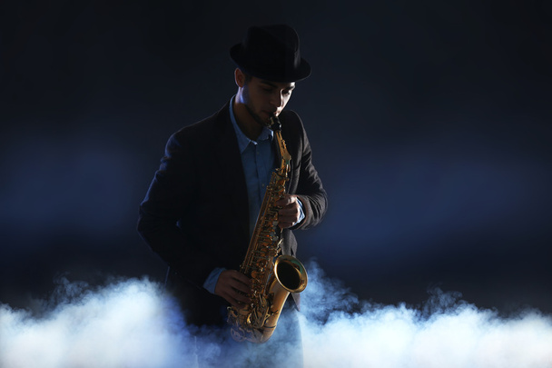 Elegant saxophonist plays jazz  - Foto, imagen