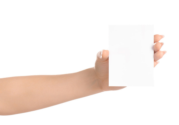 Branding and advertising theme: beautiful female hand holding a blank white paper card isolated on white background - Fotografie, Obrázek