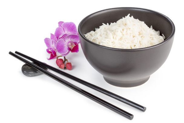 bowl of basmati rice, chopsticks and orchid flower - Φωτογραφία, εικόνα