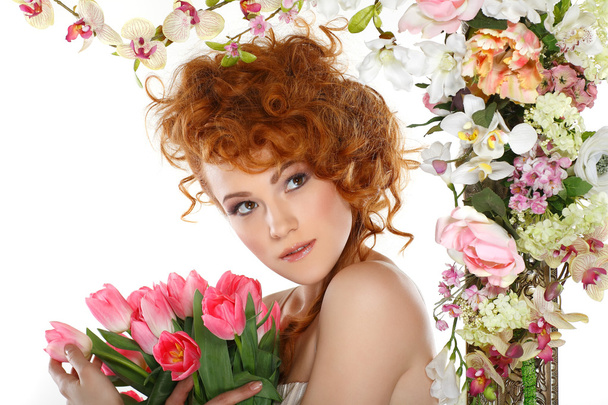 Beautiful redheaded girl with the bouquet of tulips, which stands in a gold frame, flowered, isolated on a white background - Photo, Image