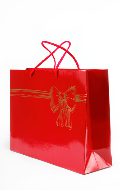 Red gift bag on a white background. - Foto, afbeelding