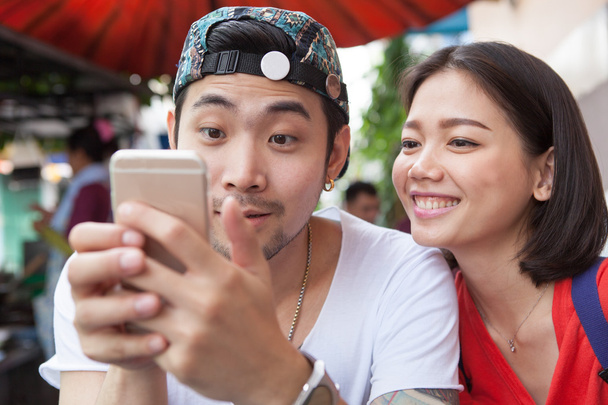asian younger man and woman watching on smart phone use for peop - Photo, Image