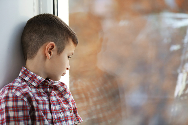 boy sitting near window - Фото, изображение