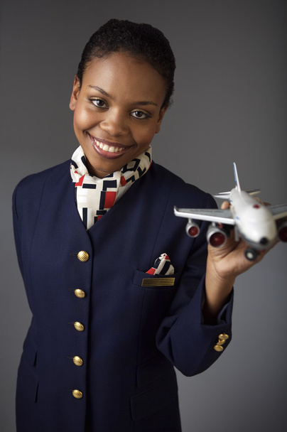 Stewardess holding model airplane - Zdjęcie, obraz