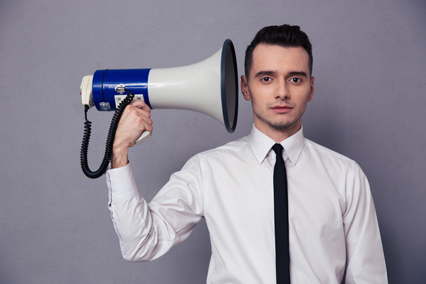Businessman holding loudspeaker - Foto, Imagen