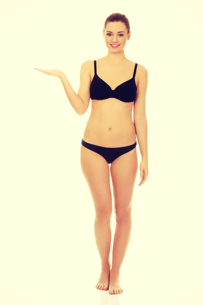 Woman in bikini with empty hand. - Zdjęcie, obraz