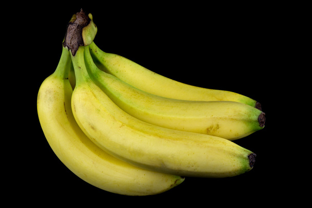 bananen op een zwarte achtergrond - Foto, afbeelding