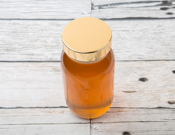 Honey In Tall Jar - Foto, afbeelding