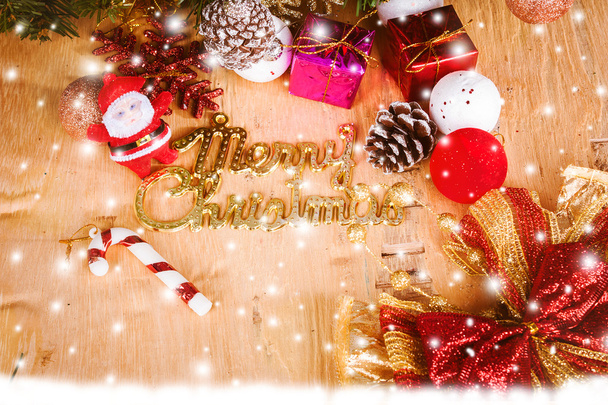 Merry Christmas on snow and wooden background - Photo, image