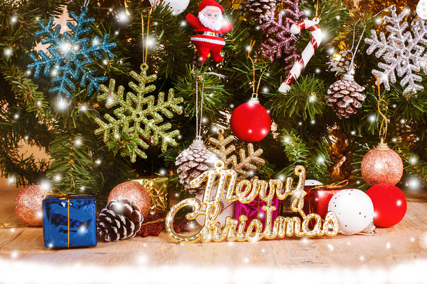 Merry Christmas on snow and wooden background - Photo, Image