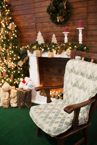 Christmas holiday background of wooden chair against decorated C - Photo, Image