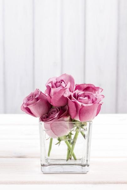 Bouquet of pink roses in glass vase - Fotoğraf, Görsel