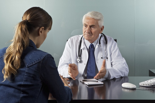 Doctor working with patient in office - Photo, Image