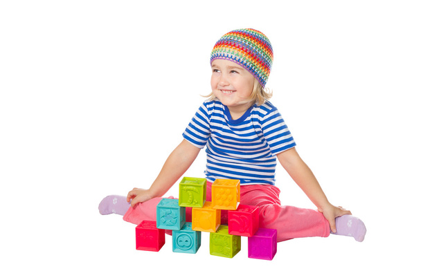 Little girl playing cubes sitting .  - Фото, изображение