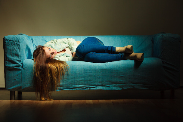 Sad woman laying on couch - Foto, immagini