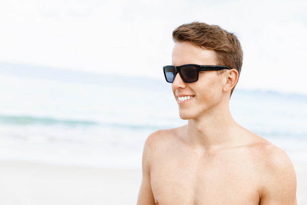 Handsome man posing at beach - Photo, Image