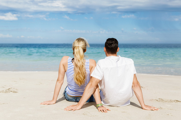 Romantic young couple sitting on the beach - Photo, Image