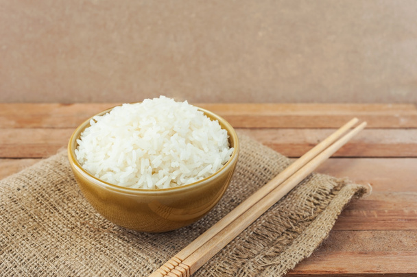 Biały ryż w misce brązowy drewno pałeczkami - Zdjęcie, obraz