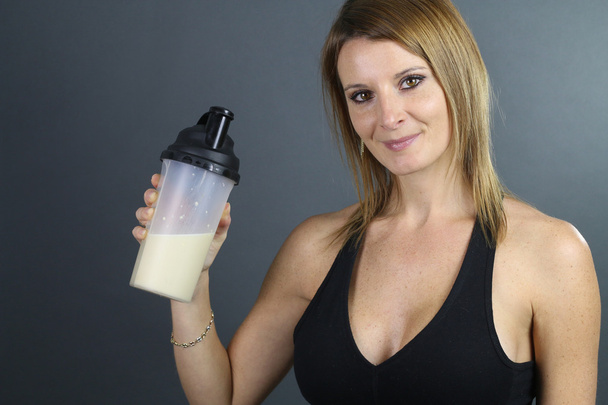 beautiful woman showing a protein shake - Photo, Image