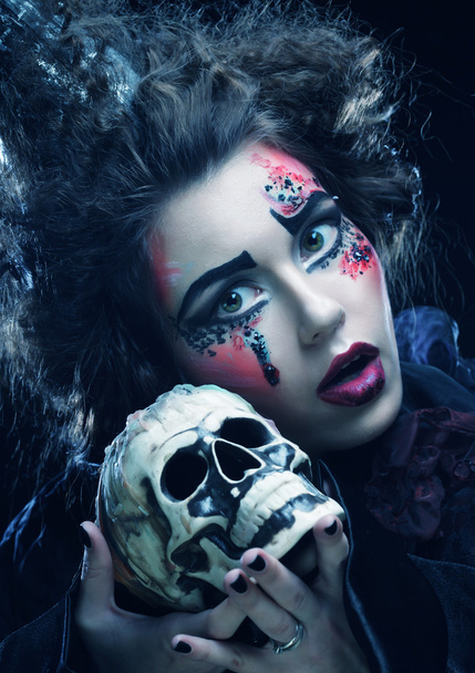 Picture a beautiful fantasy woman with skull. Halloween theme. - Photo, Image