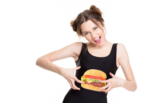 Woman in top with hamburger print joking and touching belly  - Fotografie, Obrázek
