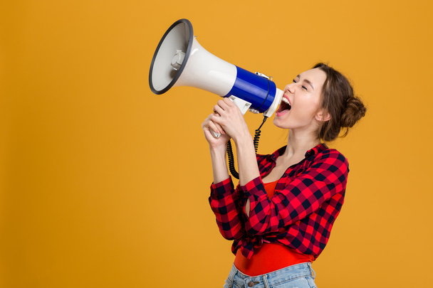 Funny excited young woman shouting in megaphone  - Foto, Imagen