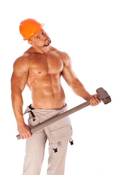 Handsome builder with a sledgehammer and sexy body - Zdjęcie, obraz