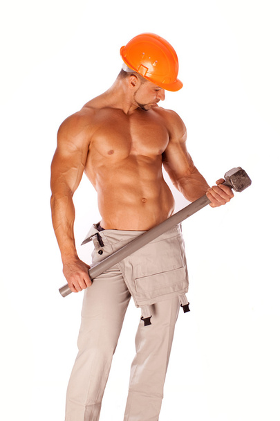 Handsome builder with a sledgehammer and sexy body - Fotó, kép