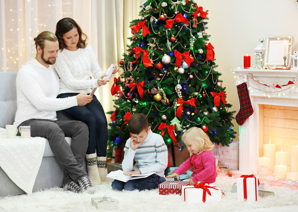 Christmas family in holiday living room - 写真・画像