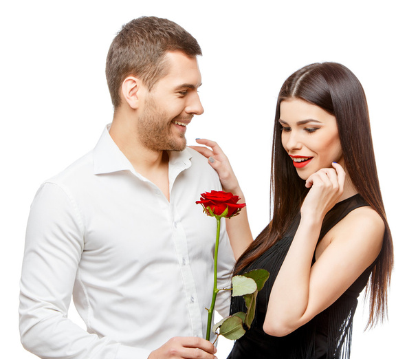 Young beautiful couple with flowers isolated on white - 写真・画像