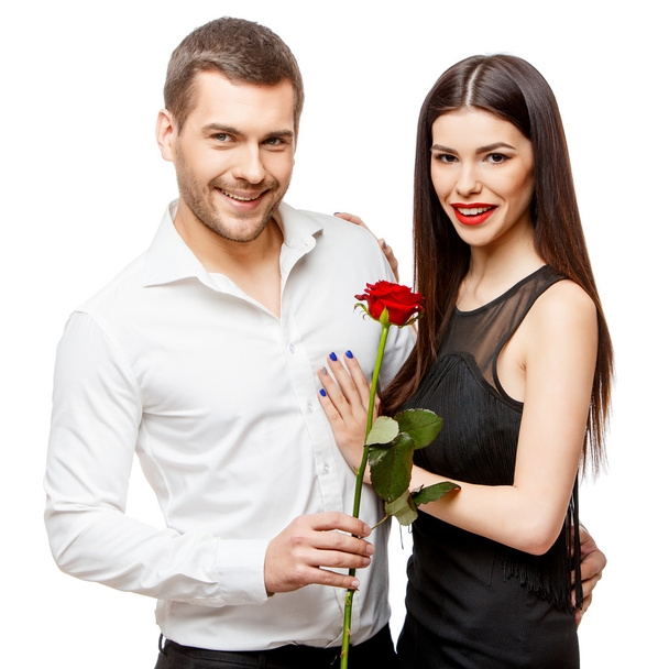 Young beautiful couple with flowers isolated on white - Foto, Bild
