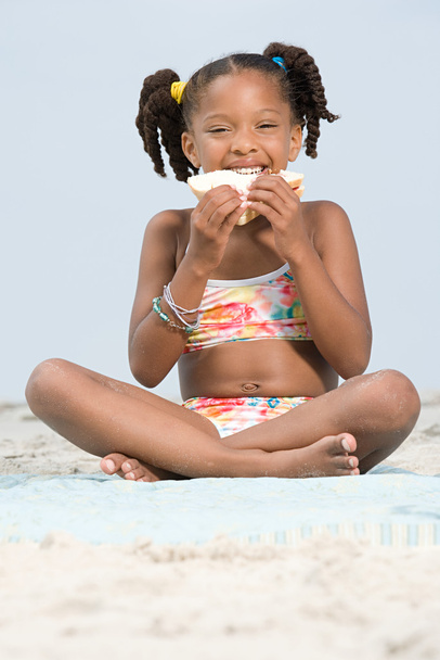 Girl eating sandwich on beach - Photo, Image