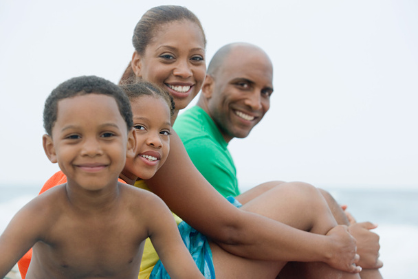 Family smiling on beach - Photo, Image