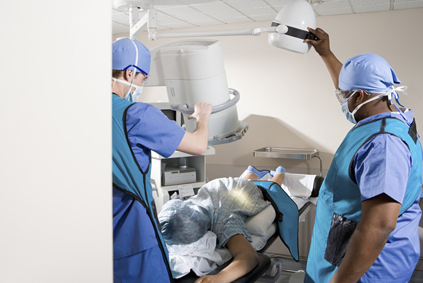 Surgeons with patient in operating theatre - Photo, Image