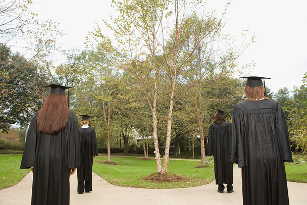 Female graduates walking down paths - Photo, Image