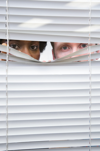 Colleagues looking through blinds - Photo, Image