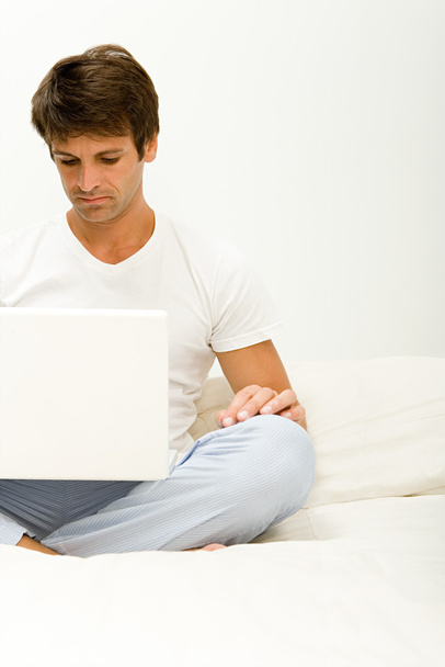 Man frowning at laptop computer - Photo, Image