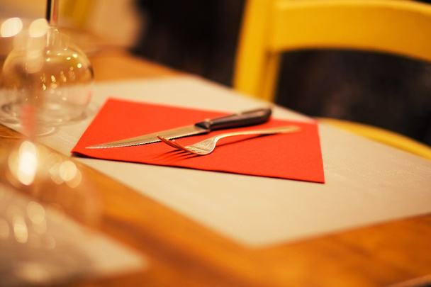 table setting with napkin, silverware in a bright red color - 写真・画像