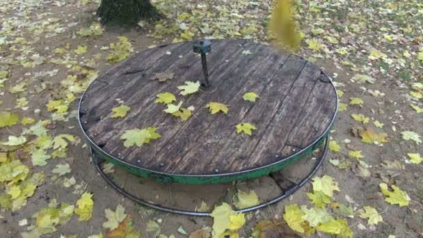 Yellow maple leaves falling on children playground equipment - Footage, Video