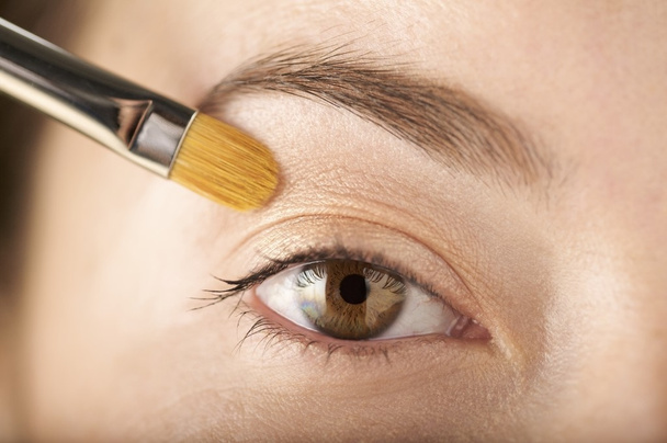 woman applies eyeshadow with a brush - Photo, Image