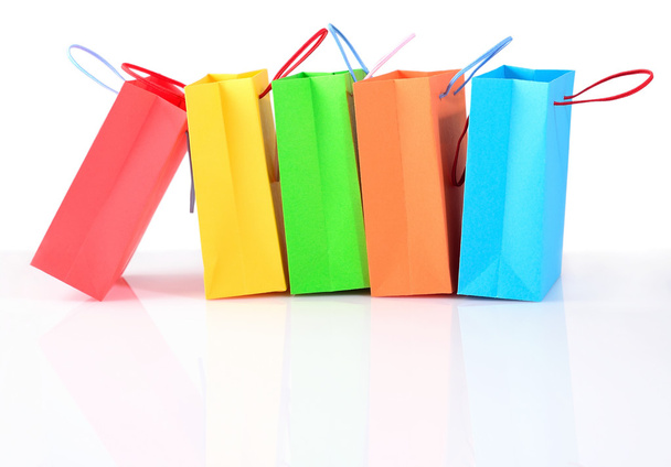 Shopping colorful sale paper bags close-up on a white - 写真・画像