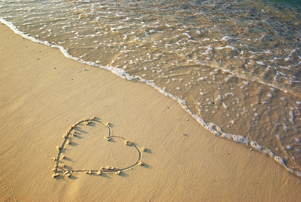 Heart drawn in the sand.  - Fotó, kép