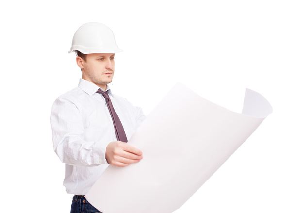 Young engineer looking at blueprint isolated on white background - Foto, Imagem